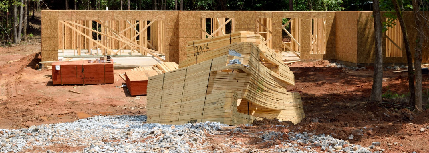 Stack of lumber ready to be added to a framed house