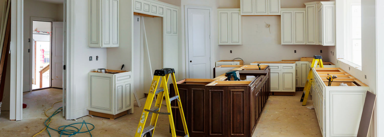 Brown and white kitchen cabinets awaiting countertops