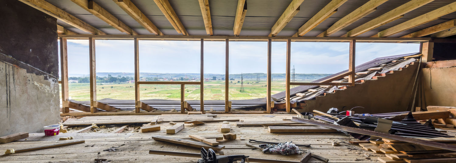 Room gutted down to the studs with a spacious view of a prairie